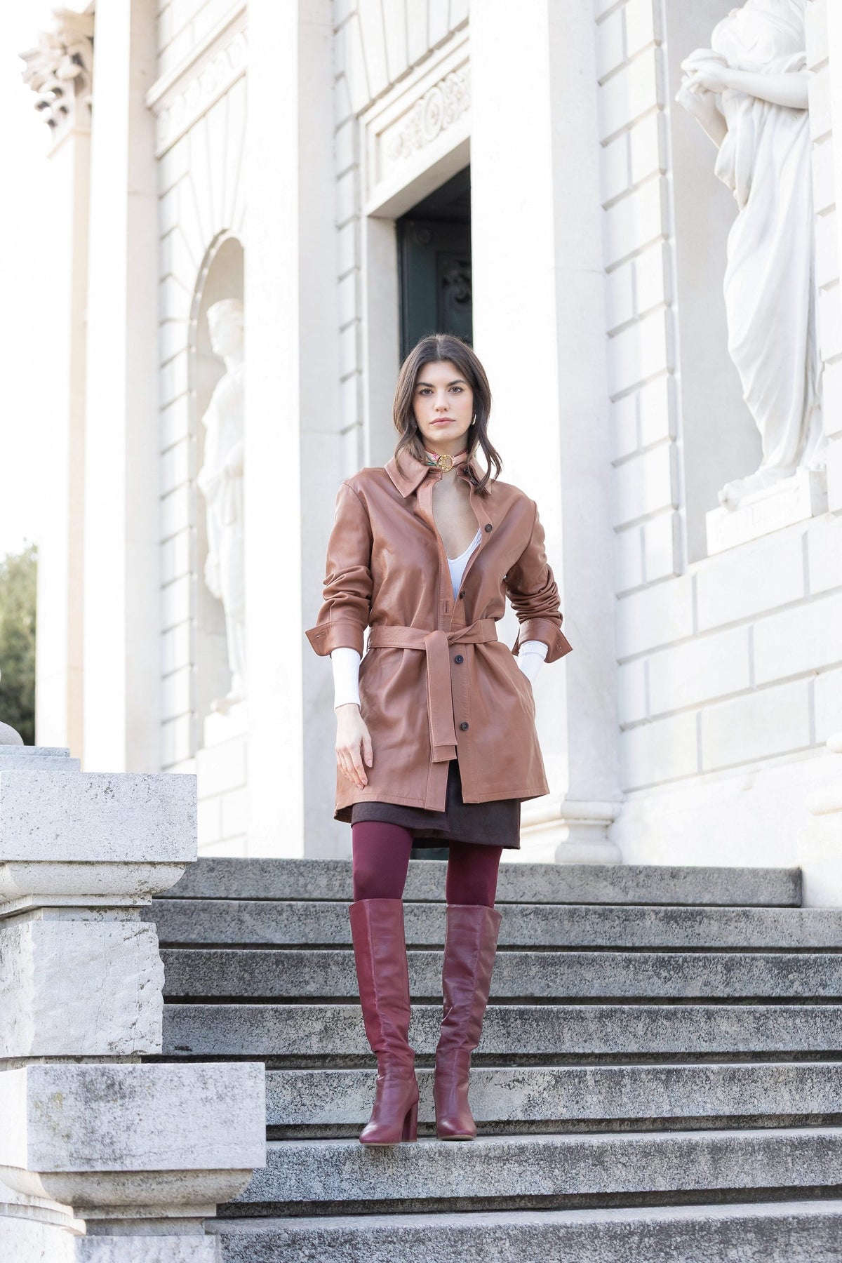 Woman in a leather jacket with a MEVOY MeSilk at the neck on the steps of a villa on Lake Como